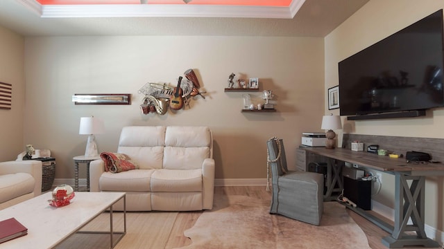 office area featuring a raised ceiling and light wood-type flooring