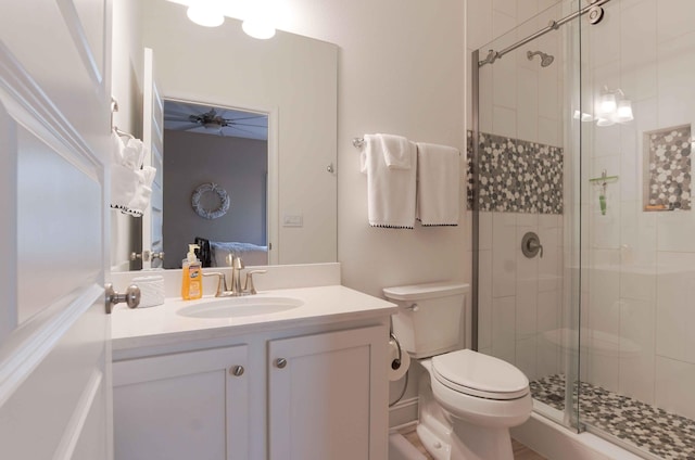 bathroom with ceiling fan, an enclosed shower, toilet, and large vanity