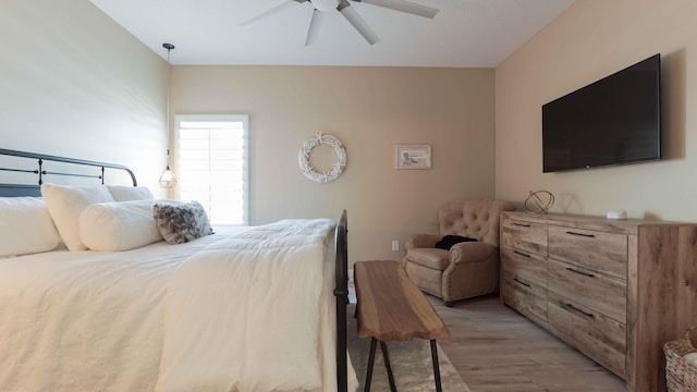 bedroom with light hardwood / wood-style flooring and ceiling fan