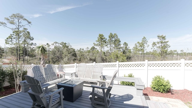 wooden terrace with a fire pit