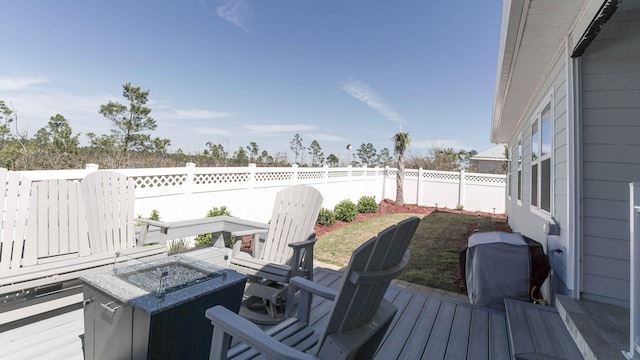 wooden deck with a fire pit