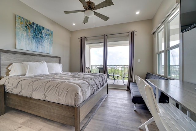 bedroom featuring light hardwood / wood-style floors, ceiling fan, and access to exterior