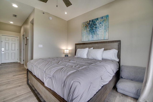 bedroom with light hardwood / wood-style flooring and ceiling fan