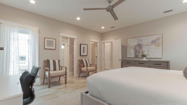 bedroom featuring light hardwood / wood-style flooring, ceiling fan, and multiple windows