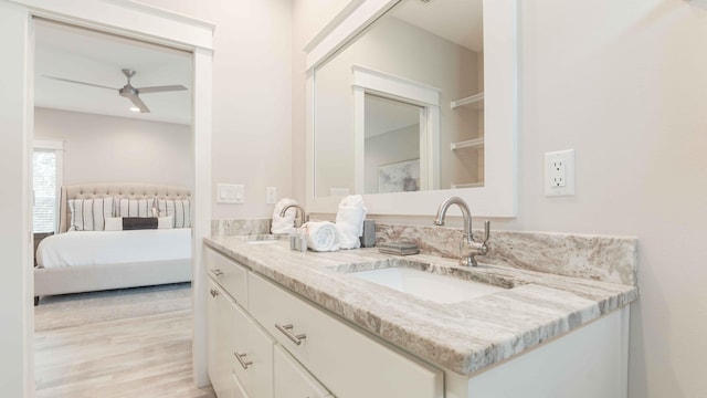 bathroom with hardwood / wood-style floors, large vanity, and ceiling fan