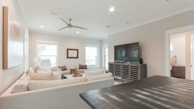 living room featuring ornamental molding and ceiling fan