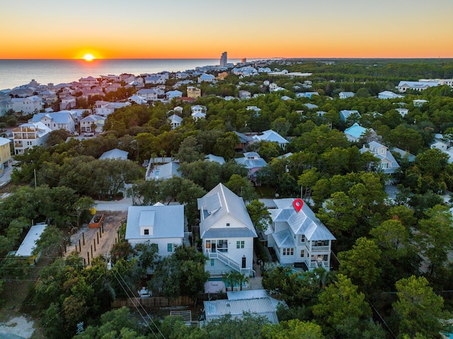 aerial view at dusk with a water view