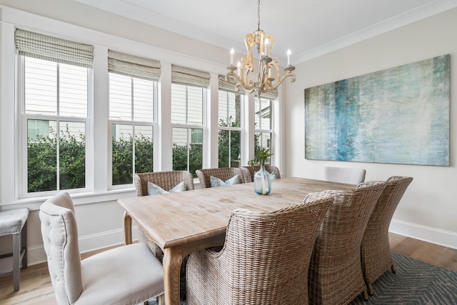 dining space with dark hardwood / wood-style floors, an inviting chandelier, and ornamental molding