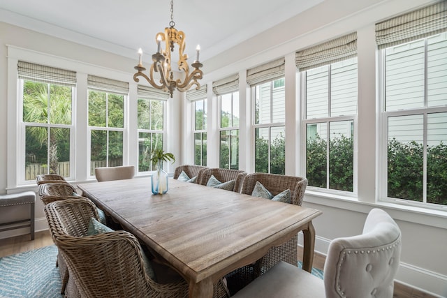 sunroom with a chandelier