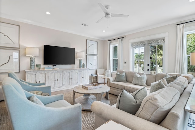 living room with a healthy amount of sunlight, french doors, ceiling fan, and light hardwood / wood-style floors