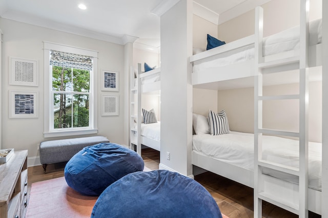 bedroom featuring ornamental molding and dark hardwood / wood-style flooring