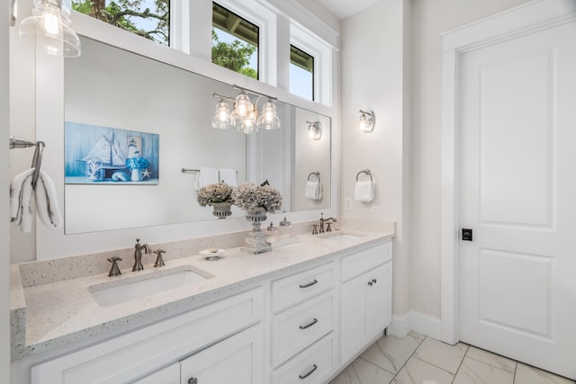 bathroom with tile flooring, vanity with extensive cabinet space, and dual sinks