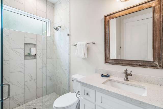 bathroom featuring walk in shower, vanity, and toilet