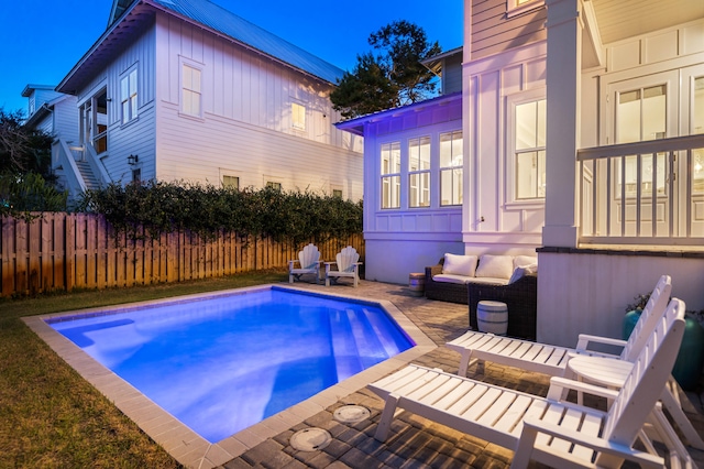 view of swimming pool featuring a patio and an outdoor living space