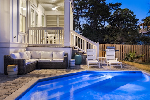 view of swimming pool featuring an outdoor living space, ceiling fan, and a patio area