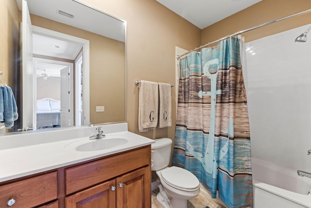 full bathroom with tile flooring, shower / tub combo, vanity with extensive cabinet space, and toilet