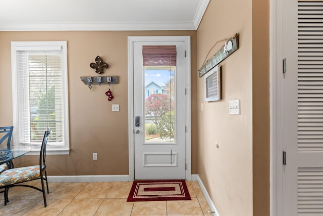 tiled foyer featuring ornamental molding and a healthy amount of sunlight