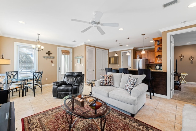 carpeted living room with ceiling fan with notable chandelier and crown molding