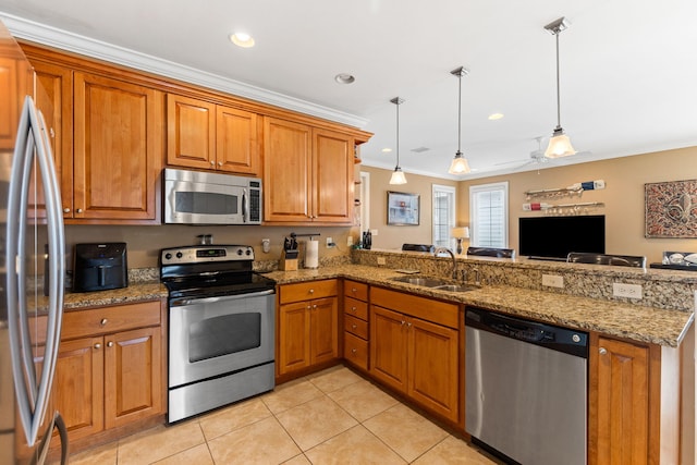 kitchen with ornamental molding, hanging light fixtures, appliances with stainless steel finishes, and kitchen peninsula