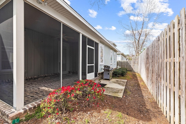 view of yard featuring a patio and a sunroom