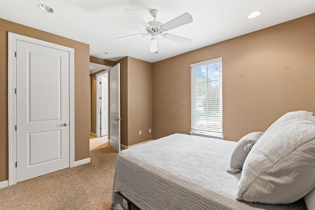 bedroom with light colored carpet and ceiling fan