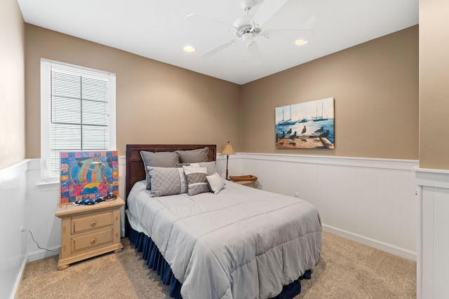 bedroom featuring ceiling fan and light carpet