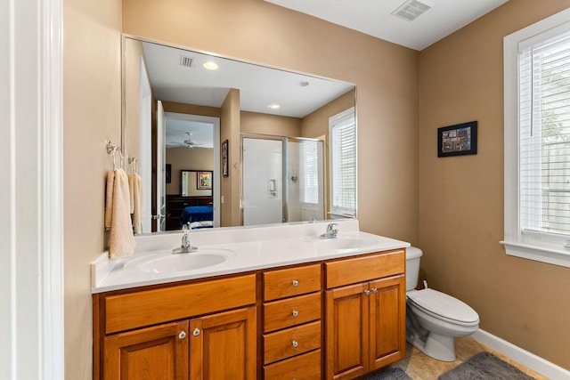 bathroom featuring tile flooring, ceiling fan, large vanity, dual sinks, and toilet