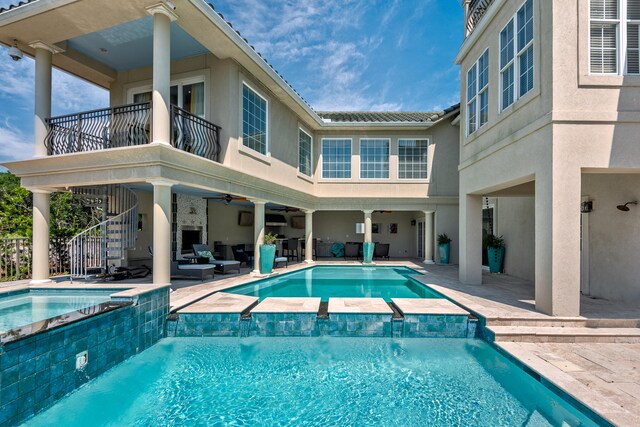 view of swimming pool featuring a patio, ceiling fan, and an outdoor hangout area