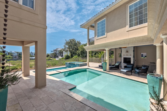 view of swimming pool with an in ground hot tub and a patio