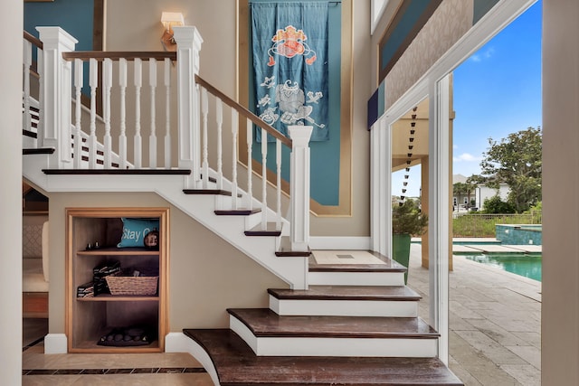 staircase featuring light tile flooring