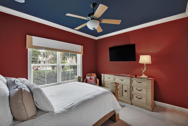 carpeted bedroom with ornamental molding and ceiling fan