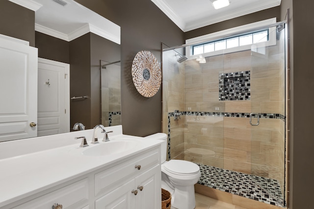 bathroom featuring ornamental molding, vanity with extensive cabinet space, toilet, and a shower with shower door