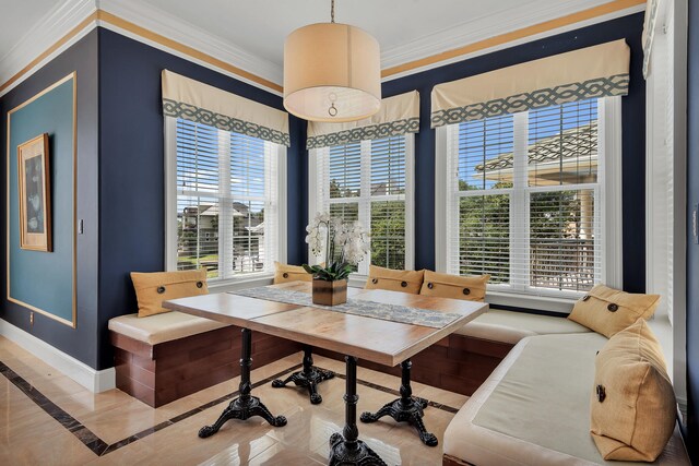 dining space with plenty of natural light and ornamental molding