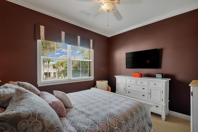 carpeted bedroom with ornamental molding and ceiling fan