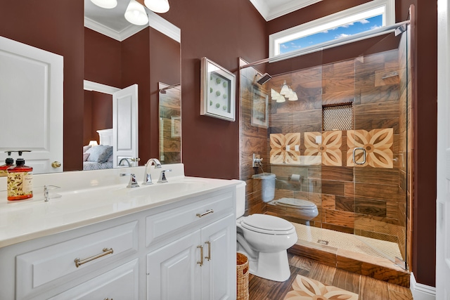 bathroom featuring ornamental molding, tiled shower, oversized vanity, and toilet