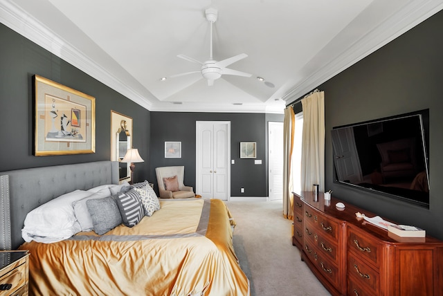 carpeted bedroom featuring a closet, ceiling fan, and crown molding