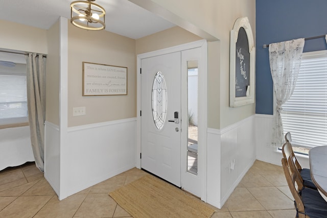 foyer featuring light tile patterned floors and a wealth of natural light