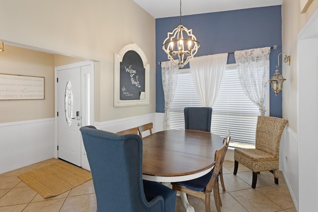 dining area with a chandelier and light tile patterned floors