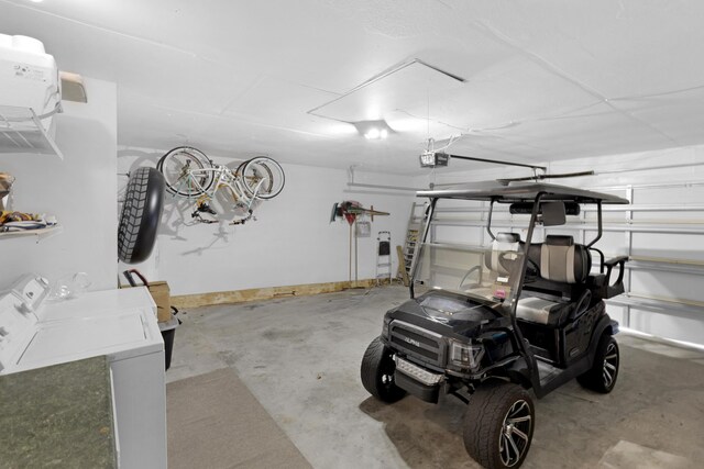 garage featuring a garage door opener and washing machine and clothes dryer