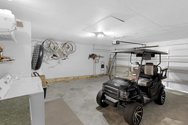 garage featuring washing machine and clothes dryer and a garage door opener