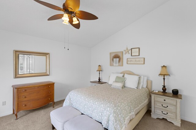 carpeted bedroom featuring ceiling fan and vaulted ceiling