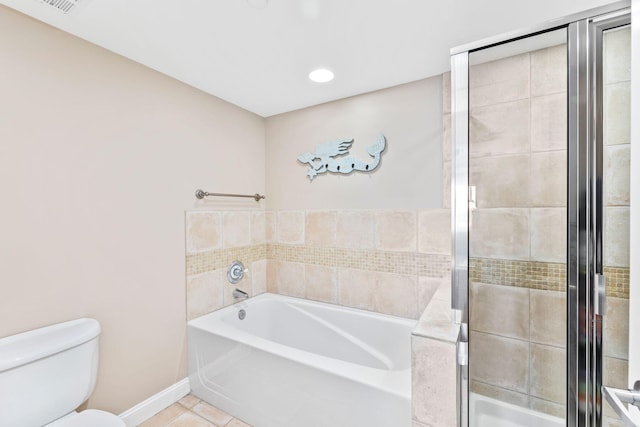 bathroom with toilet, tile patterned flooring, and plus walk in shower