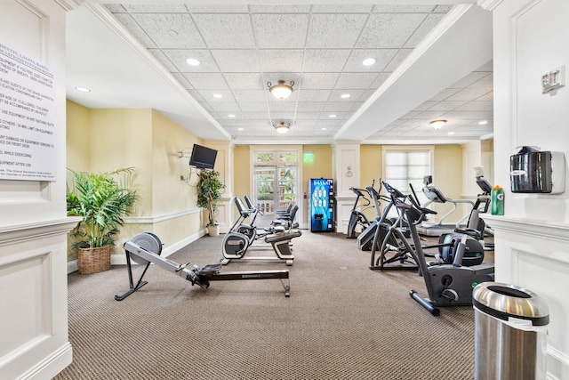 exercise room with carpet floors and a drop ceiling