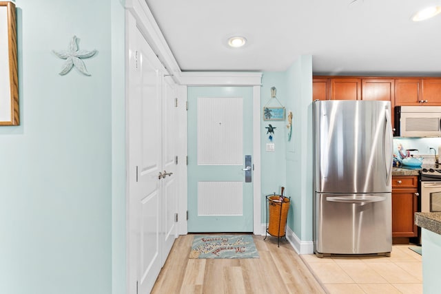 kitchen featuring stainless steel appliances and light tile patterned floors