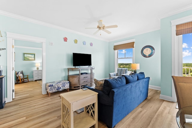 living room with crown molding, light hardwood / wood-style flooring, and ceiling fan