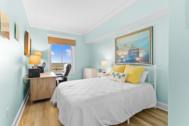 bedroom with crown molding and light wood-type flooring