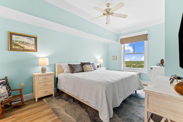 bedroom with ornamental molding, light hardwood / wood-style floors, and ceiling fan