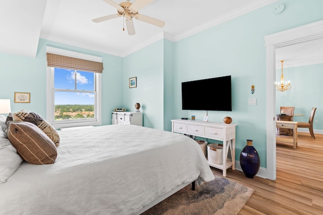 bedroom featuring crown molding, ceiling fan with notable chandelier, and light hardwood / wood-style flooring