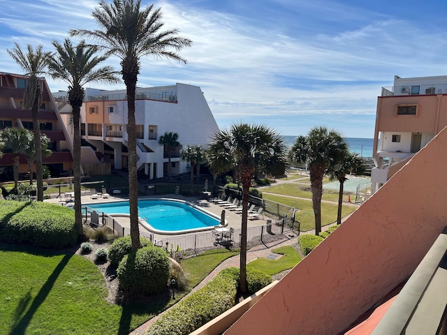 view of pool with a yard