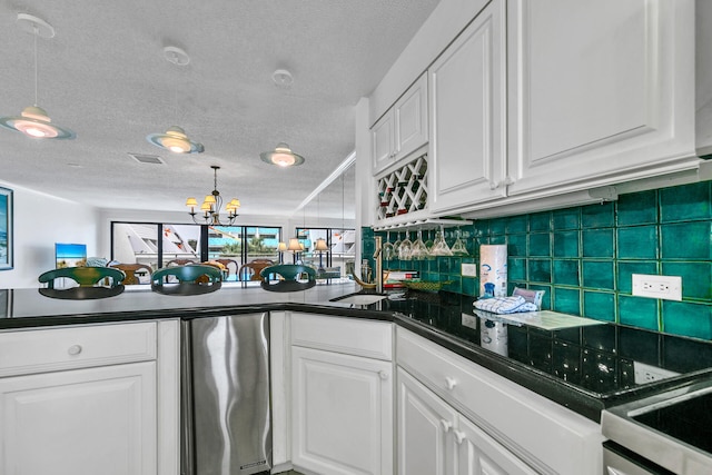 kitchen featuring decorative light fixtures and white cabinets